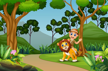 Happy zookeeper man with a lion in the jungle