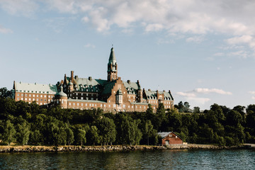 View from a cruise of an old building overlooking the ocean in Stockholm, Sweden