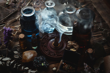 Various dried herbs and bottles on a brown wooden table. Herbal medicine, alternative medicine concept background or witch doctor.