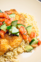Prepared tilapia fish fillet served with salad. Selective focus. Shallow depth of field. 
