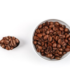 Cup and spoon filled with roasted coffee grains. coffee. layout. Flat lay.