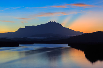 Amazing Beautiful Twilight Sunrise with Rays of light and Mount Kinabalu as background at Gayang, Tuaran, Sabah, Borneo