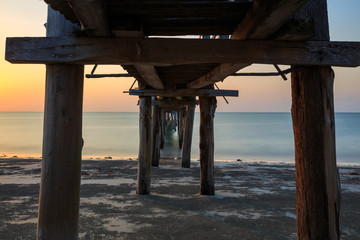 Abstract Old wooden jetty pier long exposure during beautiful sunset