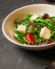 Healthy salad, leaves salad mix in a white plate and cheese (green, juicy snack). food background - Image
