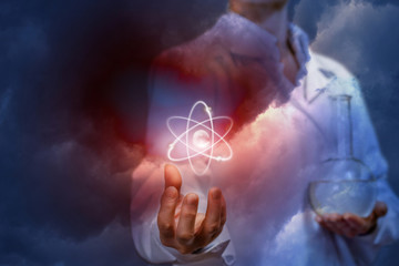 A doctor with a laboratory flask is holding an atom.