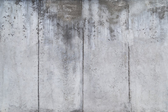 Close-up of a weathered and aged gray concrete wall. Full frame texture background of the original Berlin Wall.