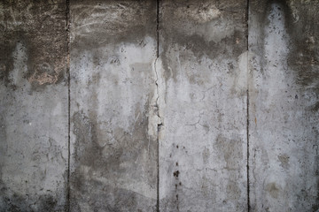 Close-up of a weathered and aged gray concrete wall with vignette. Full frame texture background of the original Berlin Wall.