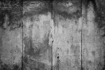 Close-up of a weathered and aged concrete wall with vignette in black and white. Full frame texture background of the original Berlin Wall. © tuomaslehtinen