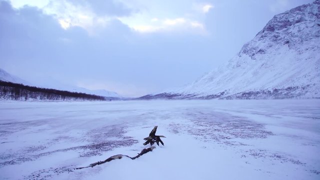 Severe weather at a frozen river in national park Sarek. Lapland, Sweden.