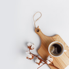 A cup of coffee on a wooden board on a white background. . Top view. Copy space.