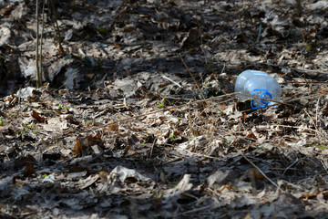 Garbage in the spring forest. The problem of ecology and pollution of nature