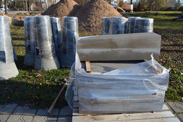 New concrete street light base group and pavement edging stack