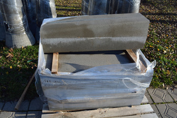 New concrete street light base and pavement edging stack