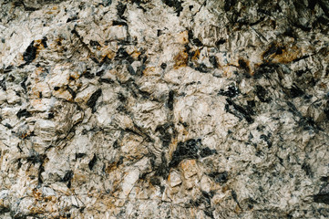Stone texture background. The surface of granite and basalt. a large rock, a stone wall. close up. place for text.
