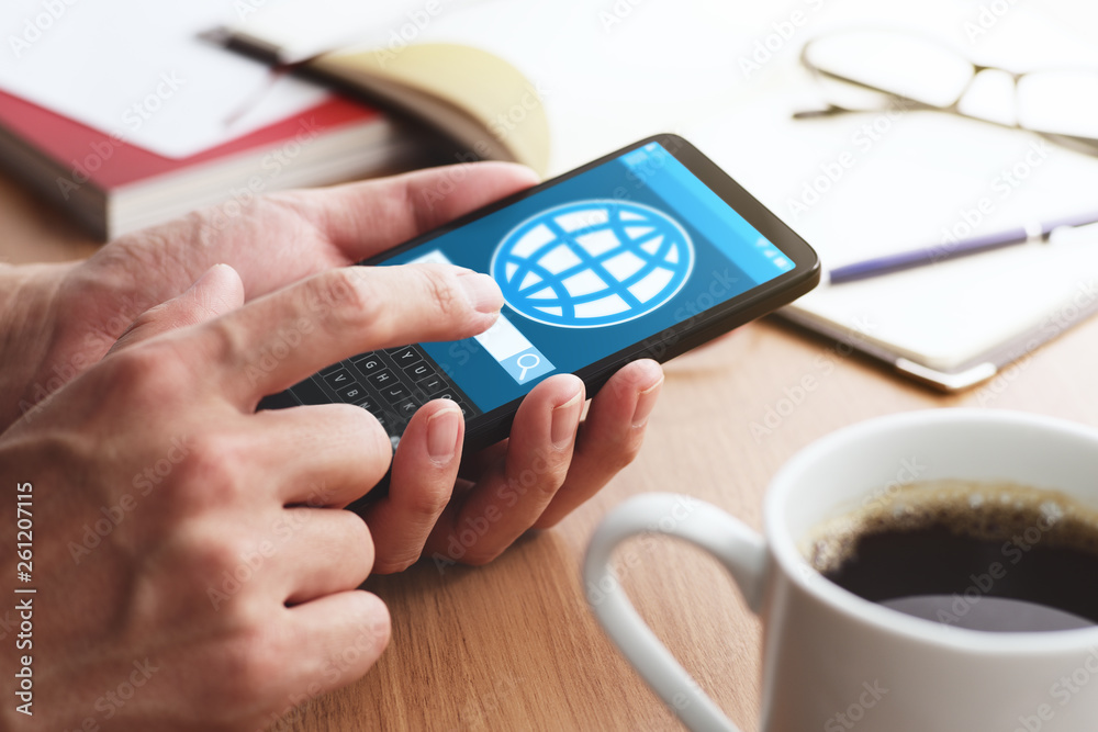 Poster Smartphone and internet concept. Closeup of male hands touching smartphone screen for using internet at table.
