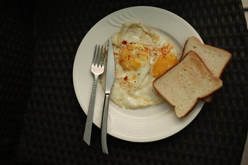 half fried egg on white plate