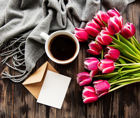 Cup of coffee and pink tulips