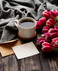 Cup of coffee and pink tulips