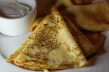 Pancakes with sour cream. Close up