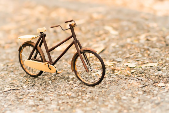 Retro styled image of a nineteenth century bicycle wooden model on a nature background