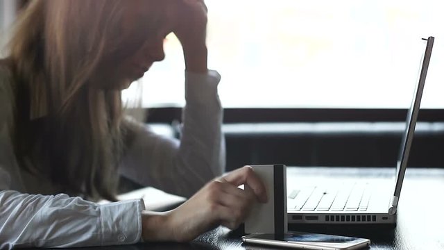 Frustrated woman entering wrong card number in online payments system on laptop