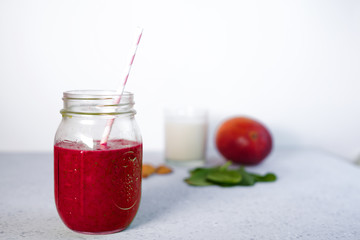 Healthy Green Reach Vitamins red Smoothie with mango, almond milk and strawberry