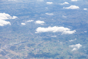 Clouds, sky and ground, looking from the plane.