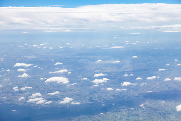 Clouds, sky and ground, looking from the plane.