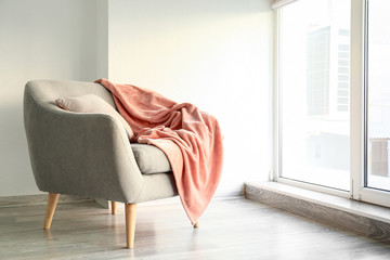 Comfortable armchair near window in room - obrazy, fototapety, plakaty