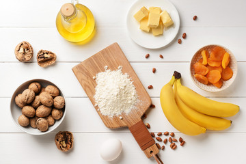 Ingredients for banana bread on white wooden table