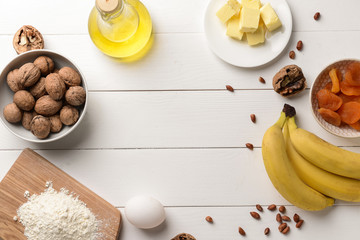Frame made of ingredients for banana bread on wooden table