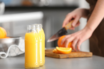 Bottles of freshly squeezed orange juice on table