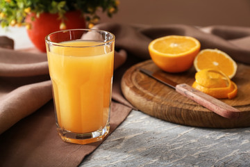 Glass of freshly squeezed orange juice on table