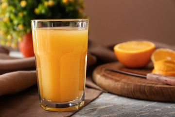 Glass of freshly squeezed orange juice on table