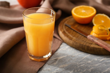 Glass of freshly squeezed orange juice on table