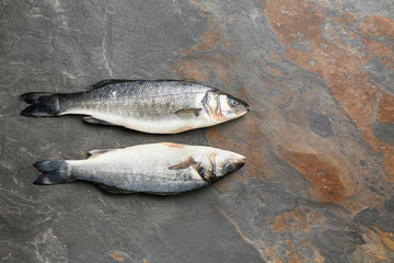 Fresh fish on grey table