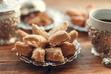 Turkish sweets with coffee on a wooden table