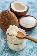 Jar with coconut oil on color background