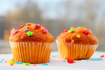 Easter muffins with condensed milk in sweet curly multi-colored topping.