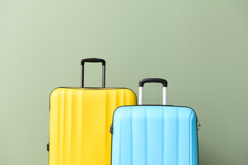 Packed suitcase on color background