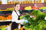 Salesgirl arranging greens