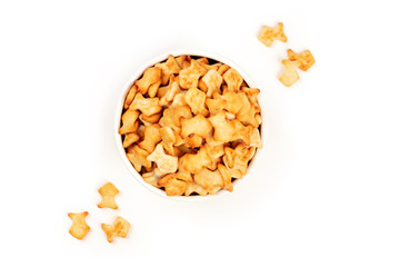 Salt goldfish crackers in a bowl, shot from above on a white background with copy space