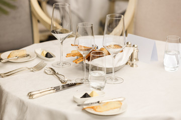 Lovely table setting for banquet in restaurant with purple orchid