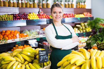 Salesgirl standing in greengrocery