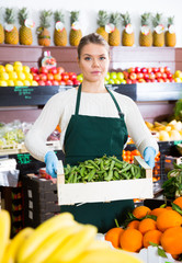Salesgirl offering green beans