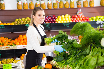 Salesgirl arranging greens