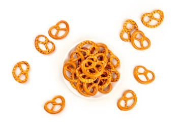 Salt pretzels, shot from the top on a white background with copy space. Party snacks with a place...