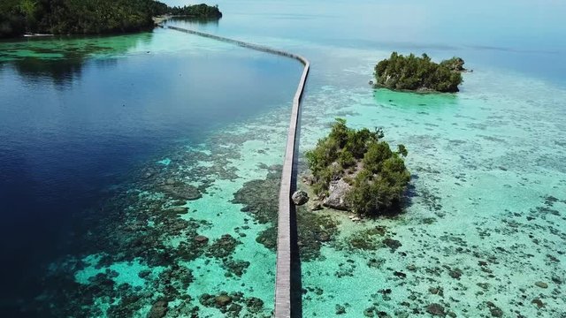 A wooden bridge connecting a sea gypsy bajo village to the main island in the togean islands in Sulawesi in Indonesia