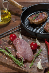 Fresh raw meat on wooden cutting board