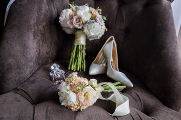 bridal bouquet with shoes on the chair